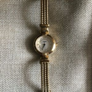 GUESS gold tone petite watch.